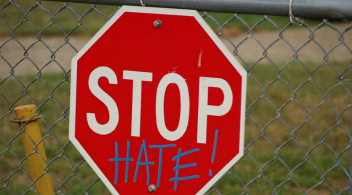 Stop sign spraypainted with the word HATE