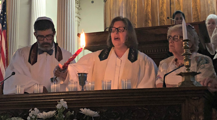 Rabbi Stephanie Alexander leads a Havdallah service behind the bimah with two others