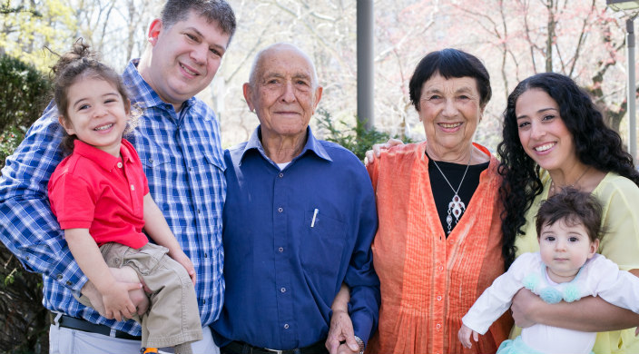 family photo of mother father two kids and one set of grandparents
