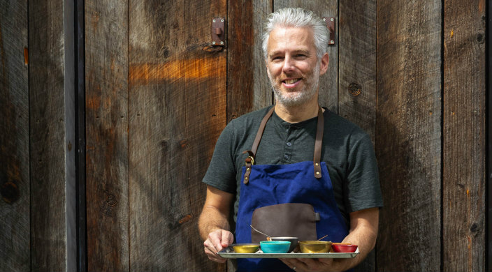 Lior Lev Sercarz, spice blender, holding a tray of spices