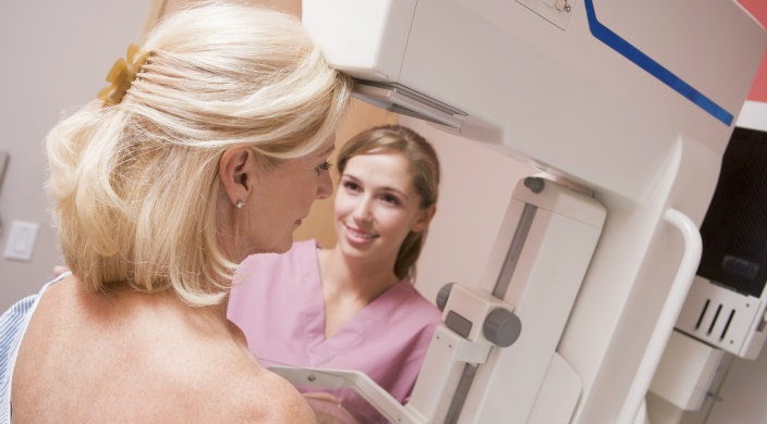 Nurse/technician helping a woman have a mammogram