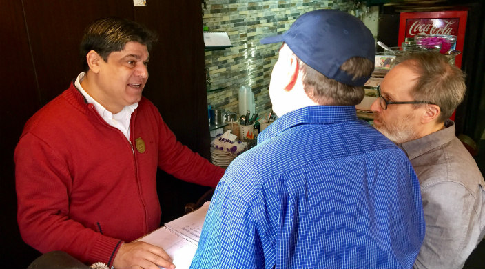 Restaurant owner talking to the blog post author and another man (Rabbi Aaron Panken, president of Hebrew Union College-Jewish Institute of Religion)