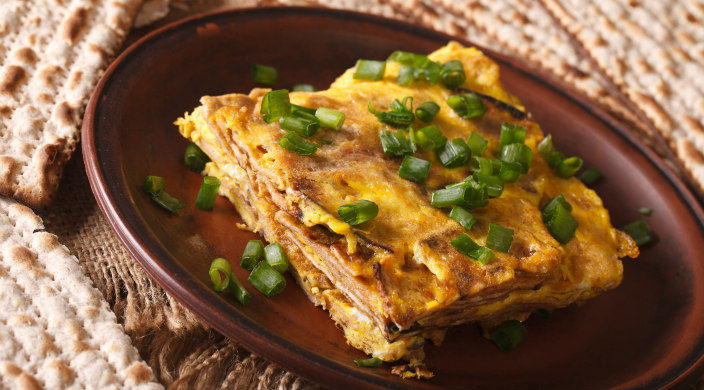 Matzah brei with green onion garnish on a plate