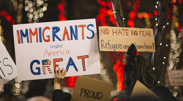 Protest sign reading IMMIGRANTS MAKE AMERICA GREAT