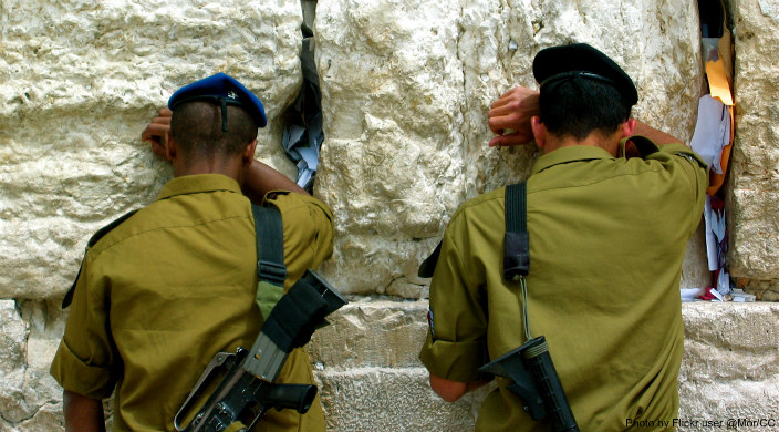 Two uniformed Israeli soldiers praying at the Western Wall