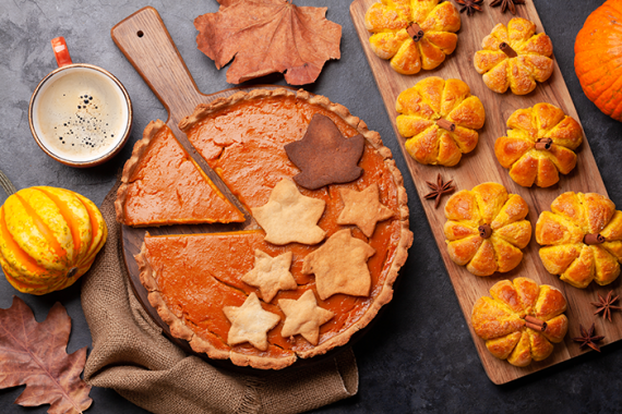a table full of pumpkins and pumpkin pie