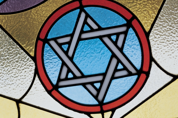 A Star of David carved into multicolored stain glass