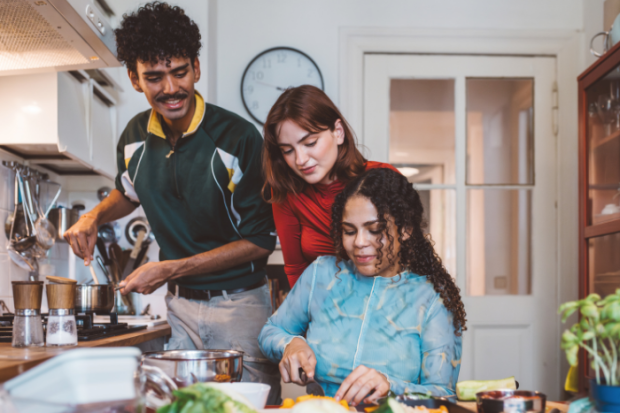 Photo of a family of three cooking in the kitchen
