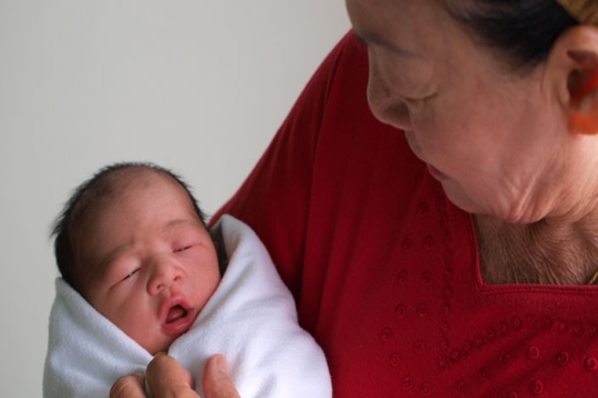 A mother holding her newborn baby boy