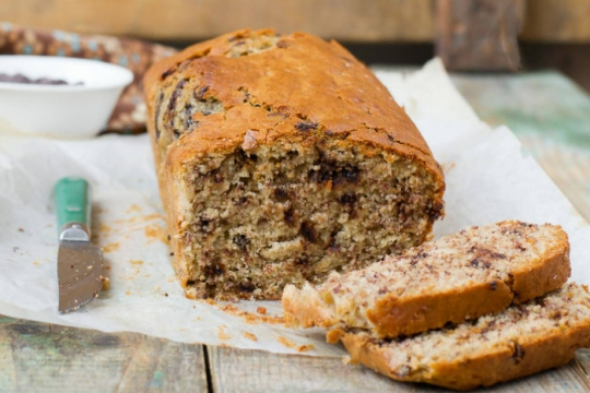 Sliced loaf of chocolate chip nut cake on a countertop
