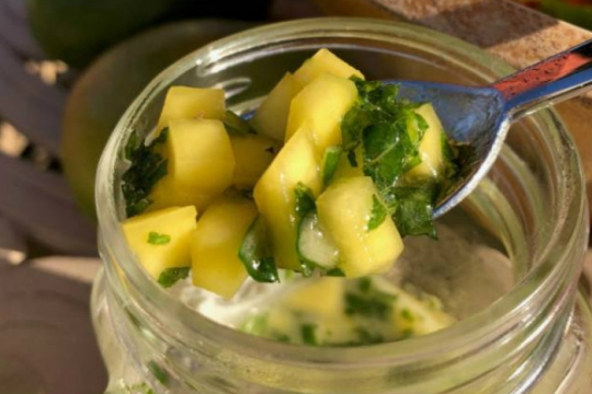 Spoonful of mango dressing in a mason jar