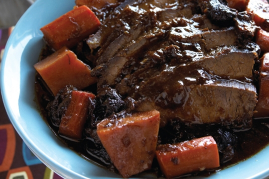 Prune and carrot tzimmes around a roast of meat