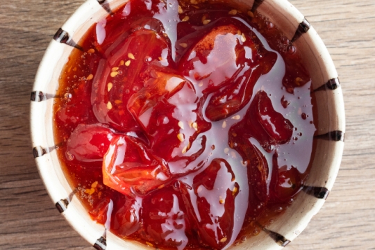 White bowl of cherry tomato jam 