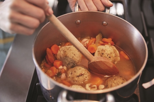 cooking matzah ball soup for passover dinner