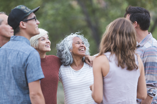 Photo of a group of people standing in a circle