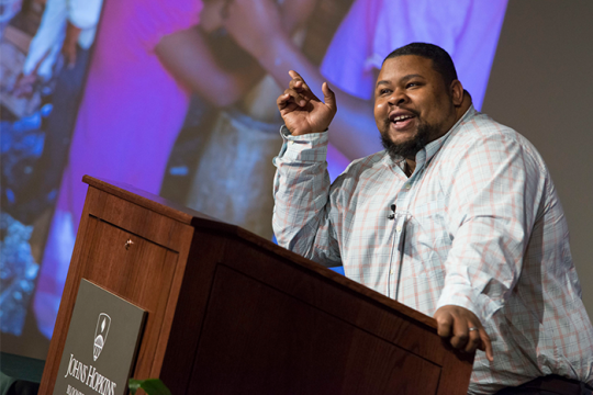 Michael Twitty making a speech in front of a podium
