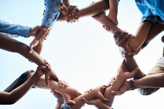 people holding hands in a circle