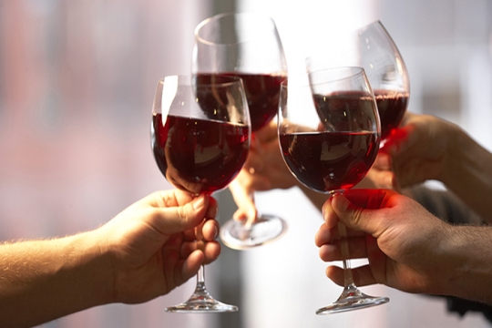 Making a toast with red wine