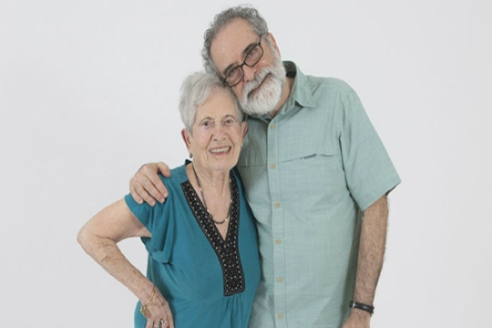 The author poses for a smiling photo with his elderly mother