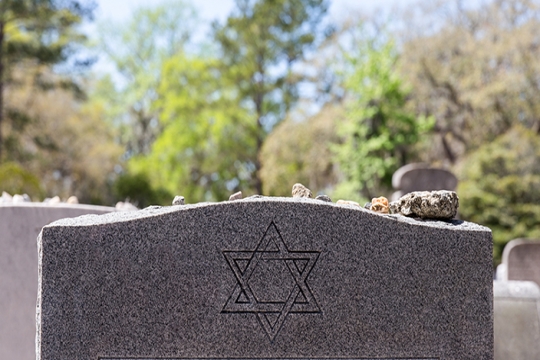 headstone with stones on it