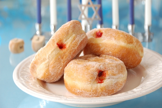 Three sufganiyot on a white plate