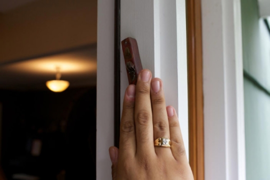 Hand touching a mezuzah