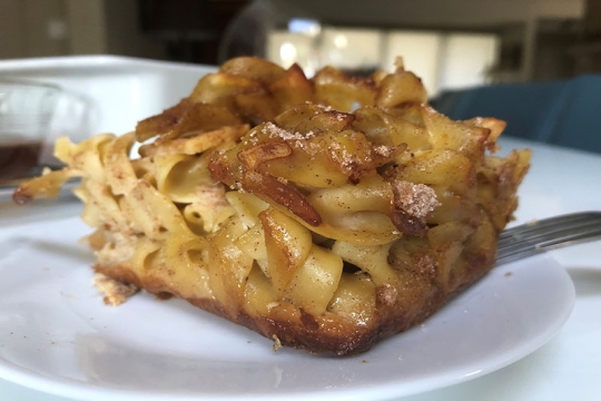 square of noodle kugel on a white plate
