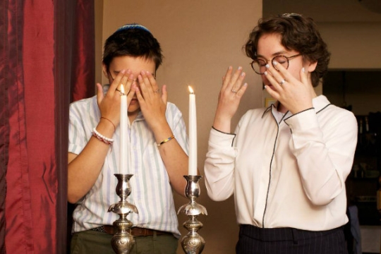 Jewish couple blessing the candles