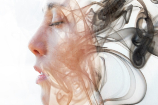 woman's face in profile/abstract with dark hair that looks like smoke