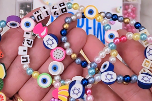 Photo of colorful beaded bracelets with Hebrew names on them