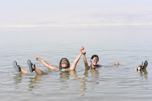 Photo of two girls floating in the dead sea in Israel