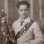 Sepia photo of a seated young man holding a violin