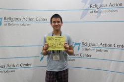 Noah Hung Spanding-Schechter with a sign that says I'm a Reform Jew and I support LGBTQ equality
