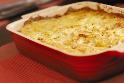 Macaroni and cheese bake in a red casserole pan