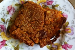 Slice of vegan sweet potato kugel on a floral plate 