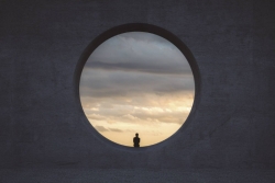 circle with view of sunset in the middle