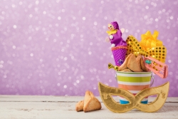 Purim gift basket against a purple background