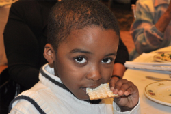 child eating a piece of matzah