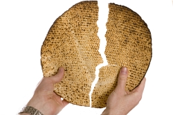hands breaking matzah