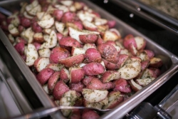 Seasoned red potatoes on a baking sheet