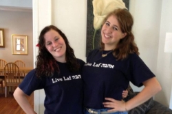 The author and a friend post together at Hillel wearing matching tee shirts with their school name written in Hebrew 