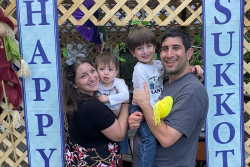 Cantor Lauren Phillips Fogelman and family in their sukkah