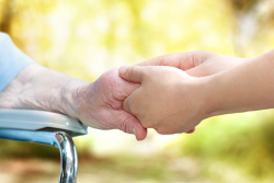old hand holding young hand