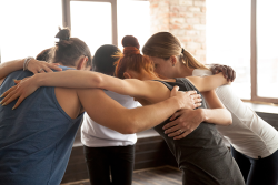 a group of women huddling up