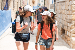 Two people laughing in an alley in the old city of Jerusalem