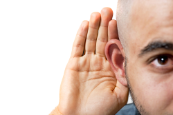 an image of a man holding his hand up to his ear symbolizing that he is listening