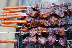 an image of steak on a bunch of skewers on a grill