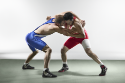 Photo of two male amatuer wrestlers locking up