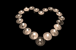 Tealights in the shape of a heart in a dark room