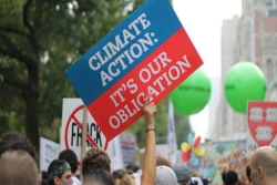Protest sign reading CLIMATE CHANGE IS OUR OBLIGATION